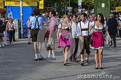People dressed in traditional bavarian clothes at the Oktoberfest in Munich Editorial Stock Photo