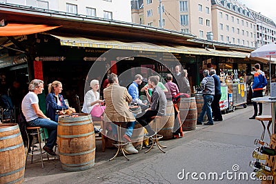 People drink wine and sit around the barrels Editorial Stock Photo