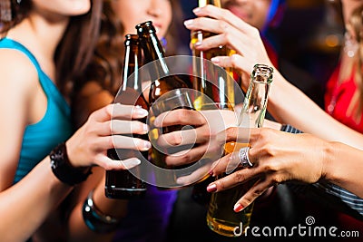 People drinking beer in bar or club Stock Photo