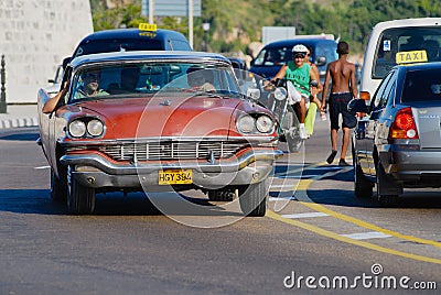 People drive vintage car in Havana, Cuba. Editorial Stock Photo