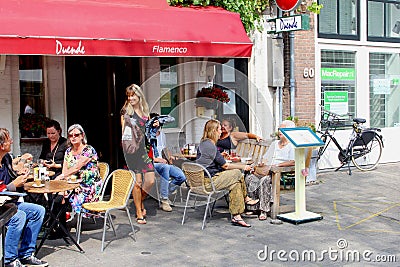 People eat drink cafe restaurant outdoor terrace, Jordaan Amsterdam, Netherlands Editorial Stock Photo