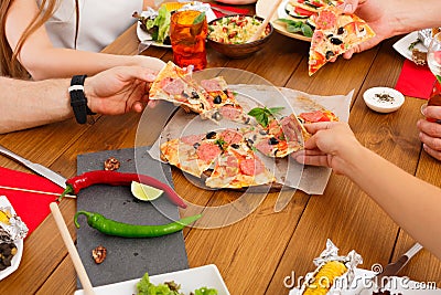 People eat pizza at festive table dinner party Stock Photo