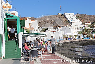 People outdoor restaurant terrace beach, Las Playitas, Fuerteventura Editorial Stock Photo