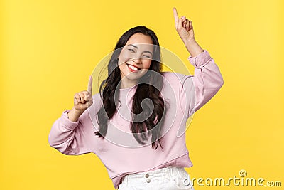 People emotions, lifestyle leisure and beauty concept. Happy carefree attractive korean girl having fun on party Stock Photo