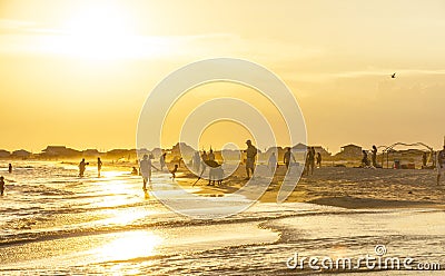 People enjoy the beautiful beach in late afternoon at Dauphin I Editorial Stock Photo