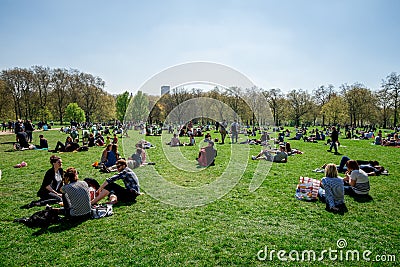 People enjoy picnic and sunny spring weather in Green park, London Editorial Stock Photo