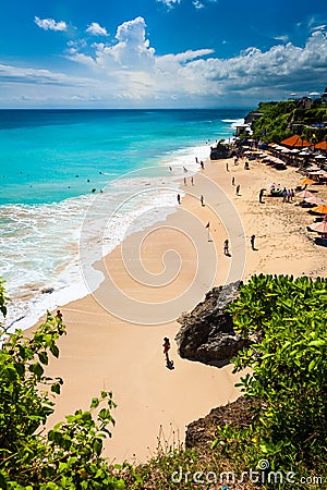People enjoy vacation on Dreamland Beach Bali Editorial Stock Photo