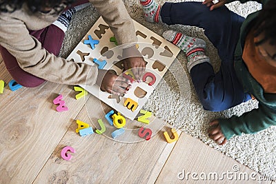 People enjoying Christmas holiday alphabets toy playing Stock Photo