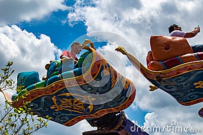 People enjoying The Magic Carpets of Aladdin sign in Magic Kingdom at Walt Disney World 1 Editorial Stock Photo