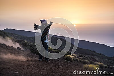 People enjoying open nature at the mountain during sunset -active woman in outdoor leisure activity with open arms - freedom and Stock Photo