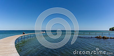 People enjoying a relaxing afternoon and the amazing views from the Infinite Bridge in Aarhus Editorial Stock Photo