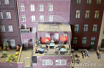 People enjoying summer on a balcony in a miniature world setup Editorial Stock Photo