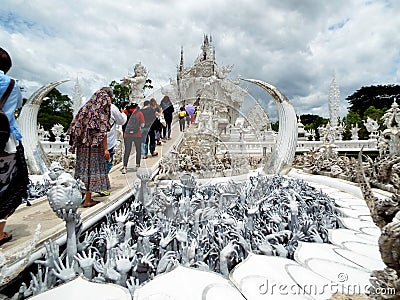 People entering the access corridor along the Hands Lake to the White Temple in Chiang Rai, Thailand Editorial Stock Photo