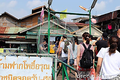 People entering the Tian market (ferry terminal entrance) after leaving a docked ferry. Editorial Stock Photo