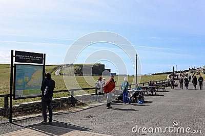 People at the entrance of the Cliffs of Moher, sea cliffs located at the southwestern edge of the Burren region in County Clare, I Editorial Stock Photo