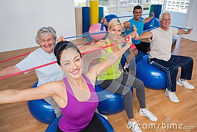 People exercising with resistance bands in gym Stock Photo