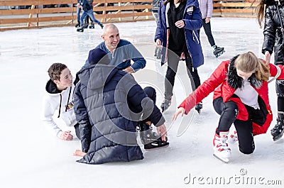 Izmail, Ukraine - February, 15, 2020: people fall on an ice rink. Ice skating. Editorial Stock Photo