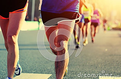 People feet on city road in marathon running race Stock Photo