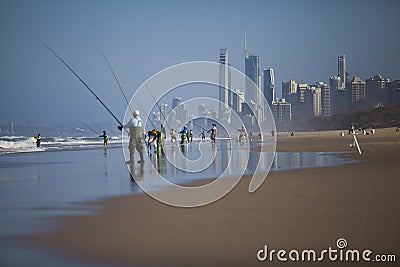 People fishing on beach Stock Photo