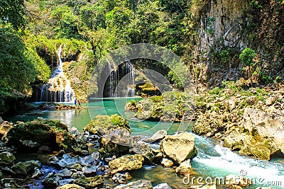 People fishing in Semuc champey natural pool, waterfall and rocks from riverside Stock Photo