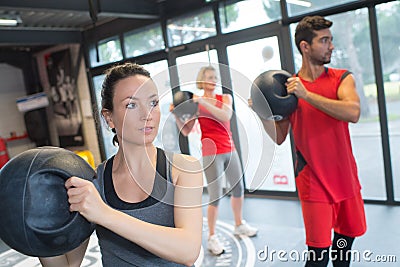 People in fitness class holding round prop Stock Photo