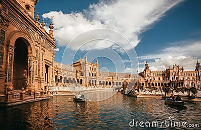 People floating in riverboats past the palace on Plaza de Espana, example of beautiful architecture of Andalusian city Editorial Stock Photo