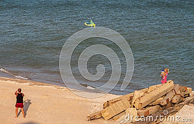 People fly a kite, by the sea Editorial Stock Photo