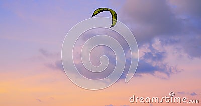 People fly kite on seashore. Pleasant pink sunset and kite hovering in the air will make the evening pleasant and Stock Photo
