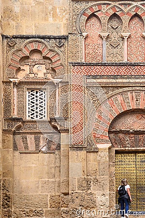 People front the Door and facade of San Ildefonso, Moorish facade of the Great Mosque in Cordoba, Andalusia, Spain Editorial Stock Photo