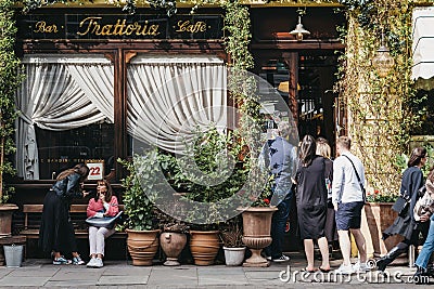 People by the front entrance of Gloria, Italian restaurant in Shoreditch, London, UK Editorial Stock Photo
