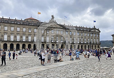 People in front of Pazo de Raxoi, a neoclassical palace on the Praza do Obradoiro Square. Santiago de Compostela, Galicia, Spain. Editorial Stock Photo