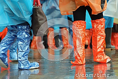 People with gaiters and rainproof raincoats during the rain Stock Photo