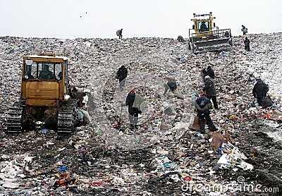 People in Garbage Dump Stock Photo