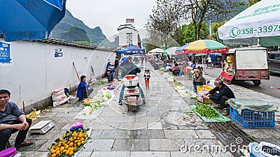 People on garden market on street in Yangshuo Editorial Stock Photo