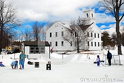 People gather on a frozen pond to ice skate and play hockey Editorial Stock Photo