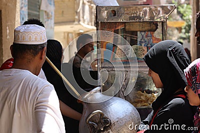 People gather infront of foul traditional Egyptian food Editorial Stock Photo