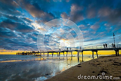 People on Glenelg Beach jetty Stock Photo