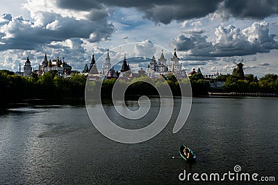 People go boating on a silver-grape pond near the Kremlin Izmaylovo Stock Photo