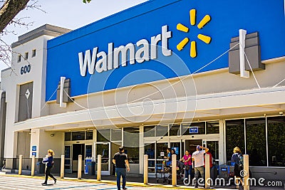 People going in and coming out of a Walmart store Editorial Stock Photo