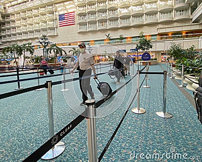 People going through Orlando International Airport MCO TSA security in masks on a slow day due to the coronavirus Editorial Stock Photo