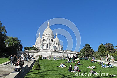 People on grass near Basilica of the Sacred Heart of Paris on Montmartre Editorial Stock Photo