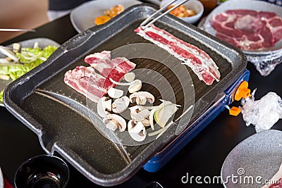 People grilling korean barbeque Stock Photo