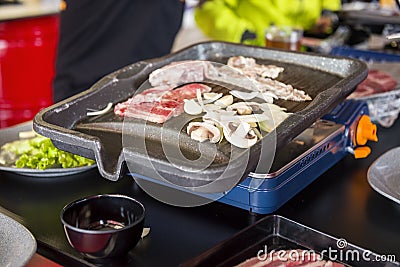 People grilling Korean barbeque Stock Photo