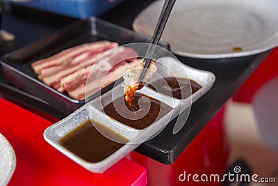 People grilling Korean barbeque Stock Photo