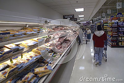 People grocery shopping at the meal counter inside a stored Editorial Stock Photo