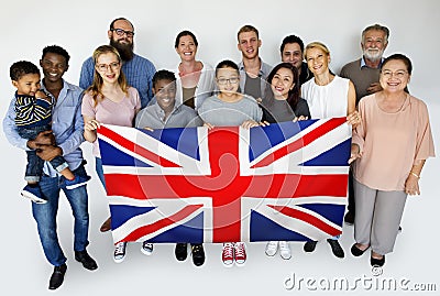 People in group holding country flag and posing for photoshoot Stock Photo