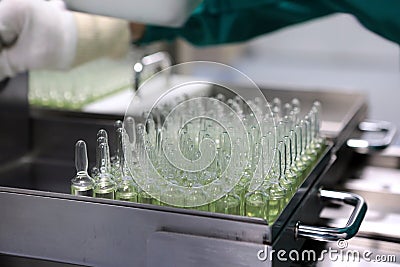 People hand holding a test tube vial sets for analysis in the gas liquid chromatograph. Laboratory assistant inserting laboratory Stock Photo