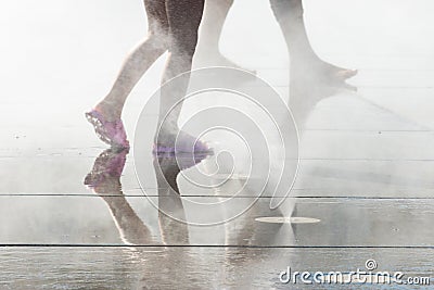 People having fun in a mirror fountain in Bordeaux, France Stock Photo