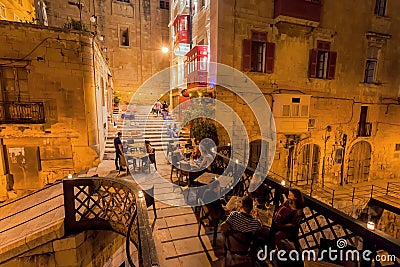 People having late dinner in restaurant on small stone bridge of historical city Editorial Stock Photo