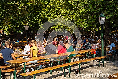 People having lunch in a biergarten Editorial Stock Photo